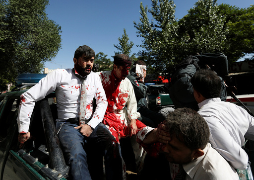 Injured men arrive to a hospital after a blast in Kabul, Afghanistan