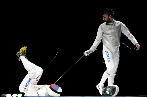 Russia's Rigin falls down as he competes against Italy's Garozzo during their men's team foil final at World Fencing Championships in Moscow