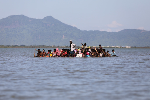 Rohingya refugees cross the Naf River with an improvised raft to reach to Bangladesh at Sabrang near Teknaf