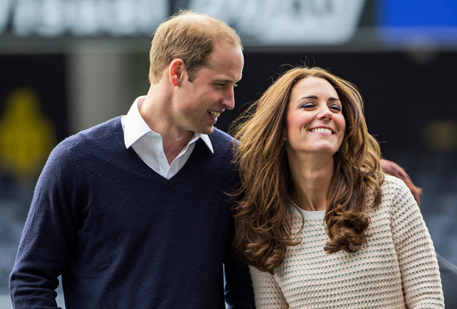 Catherine, Duchess of Cambridge, and Prince William laugh as they watch a young players' rugby tournament in Dunedin