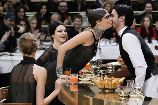 Model Delevingne kisses model Giabiconi as Jenner looks on during German designer Lagerfeld's Autumn/Winter 2015/2016 women's ready-to-wear collection for French fashion house Chanel during Paris Fashion Week