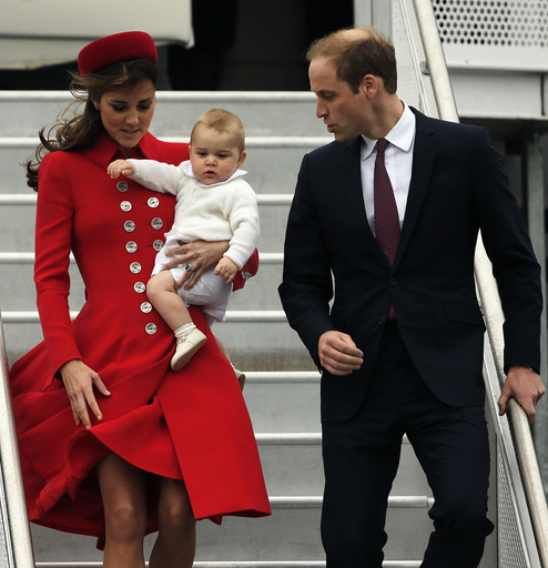 Britain's Prince William, his wife Catherine and their son Prince George disembark from their plane in Wellington