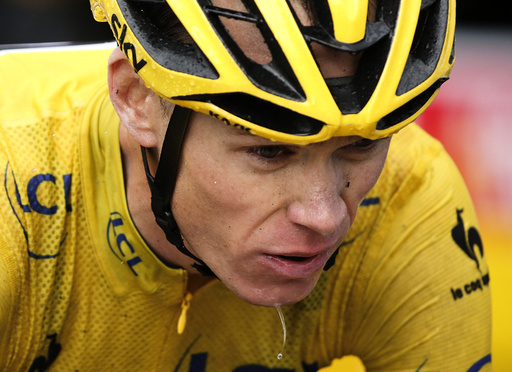 Team Sky rider Froome of Britain, race leader's yellow jersey, crosses the finish line of the 12th stage of the Tour de France cycling race