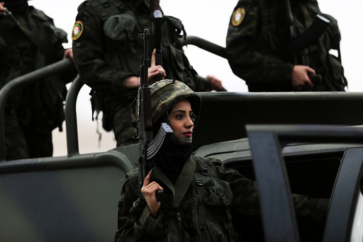 Female members of Palestinian National Security Forces take part in a graduation ceremony for young Palestinians who participated in a military training program, in the West Bank city of Jericho