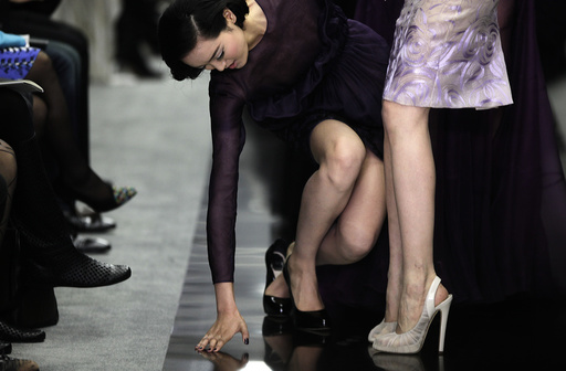 A model stumbles while presenting a creation by designer Bill Gaytten as part of his Spring/Summer 2012 collection for French fashion house Dior in Shanghai