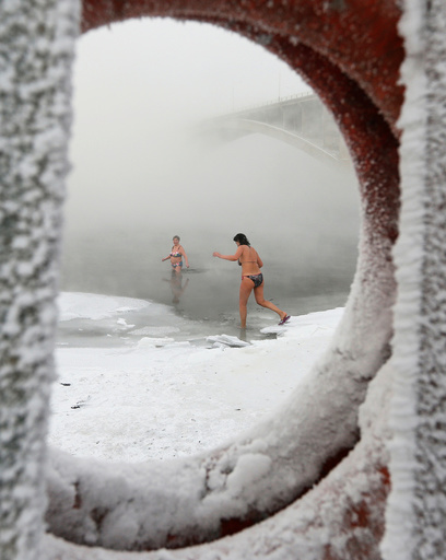 Members of the Cryophile winter swimmers club take a bath in the icy waters of the Yenisei River in Krasnoyarsk
