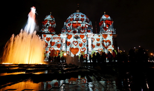 People look at a light installation at the Berlin Cathedral during the opening day of the 