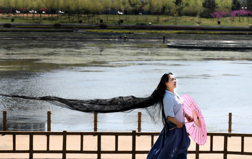 A woman with long hair poses for pictures in Weihai