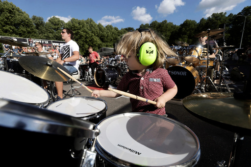 A boy together with more than 100 drummers performs during the Baltic Drummers' Summit in Riga