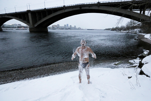 Alexander Yaroshenko, a member of the Cryophile winter swimming club, rubs himself with snow after swimming in the Yenisei River in the Siberian city of Krasnoyarsk