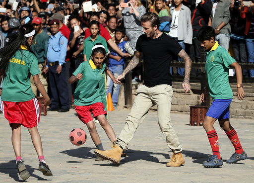 David Beckham kicks a ball during the charity match to collect funds for UNICEF at the ancient city of Bhaktapur