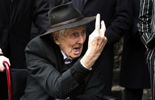 File photograph shows Great Train Robber Ronnie Biggs gesturing as he arrives for the funeral of Bruce Reynolds, at the church of St Bartholomew the Great in London