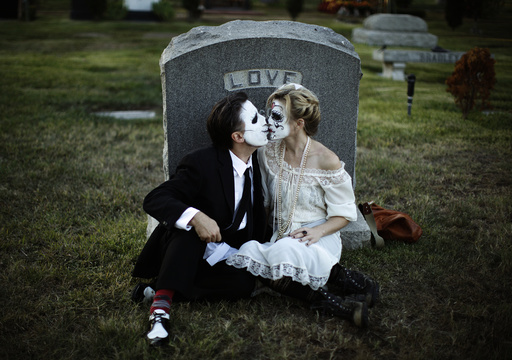 Bailey and Alexanderkiss in front of a tombstone during the 14th annual Dia de los Muertos festival at Hollywood Forever Cemetery in Los Angeles