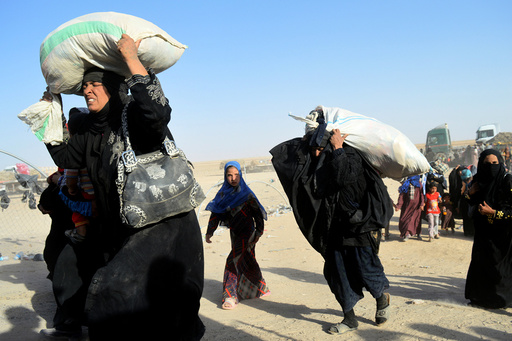 Women displaced by violence from Islamic State militants, arrive at a military base in Ramadi