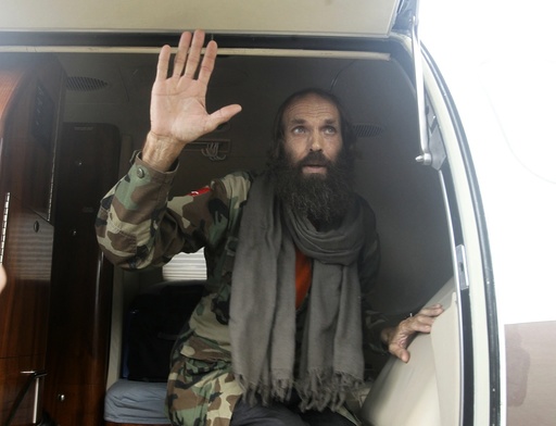 Norwegian Kjartan Sekkingstad is escorted at an airport following his release in the town of Jolo.
