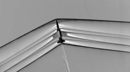 The shock wave of a T-38C supersonic jet flying over the Mojave Desert in California is seen in an undated NASA schlieren image