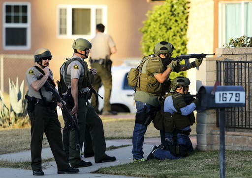 Police officers conduct a manhunt after a shooting rampage in San Bernardino