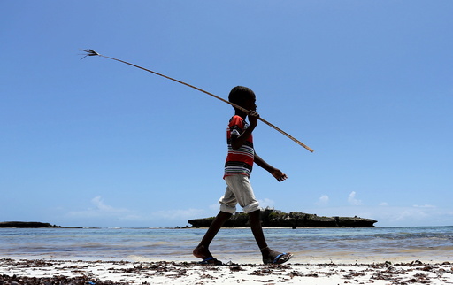 A boy walks along the Jazeera beach near Somalia's capital Mogadishu