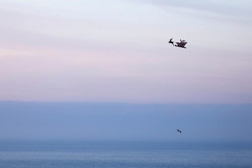 A 10-foot long remote controlled flying Santa makes a test flight over the ocean in Carlsbad, California