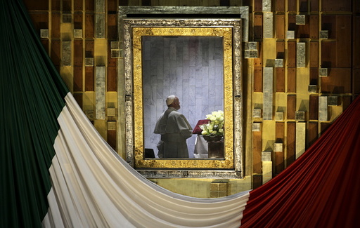 Pope Francis is seen praying in front of the image of Our Lady of Guadalupe while celebrating mass at the Basilica of Guadalupe in Mexico City
