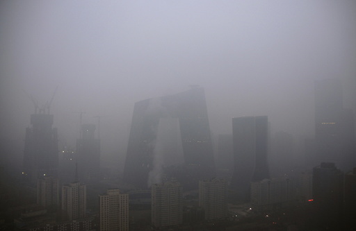 The China Central Television (CCTV) building and the Central Business District area are seen amid heavy smog after the city issued its first ever 