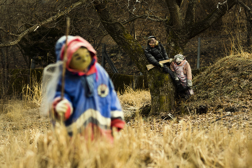 Scarecrows stand in a field in the mountain village of Nagoro