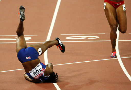 Tiffany Porter of Britain falls after competing in the women's 100 metres hurdles final during the 15th IAAF World Championships at the National Stadium in Beijing