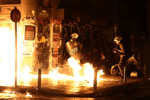 A petrol bomb explodes next to riot police during a demonstration against the visit of US President Obama in Athens
