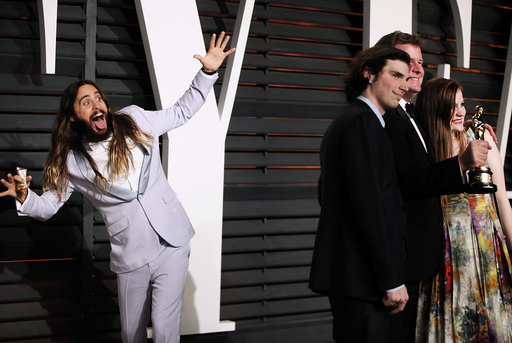 Jared Leto photobombs James W. Skotchdopole at the 2015 Vanity Fair Oscar Party in Beverly Hills