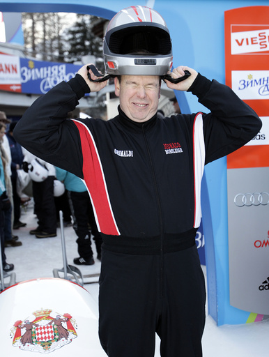 Prince Albert II of Monaco adjusts his helmet before the start of the Bobsleigh Monaco Historic race at the Olympia Run in St. Moritz