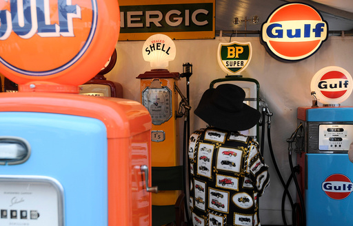 A woman views a display of old petrol pumps at the annual Goodwood Revival historic motor racing festival, celebrating a mid-twentieth century heyday of the racing circuit, near Chichester in south England