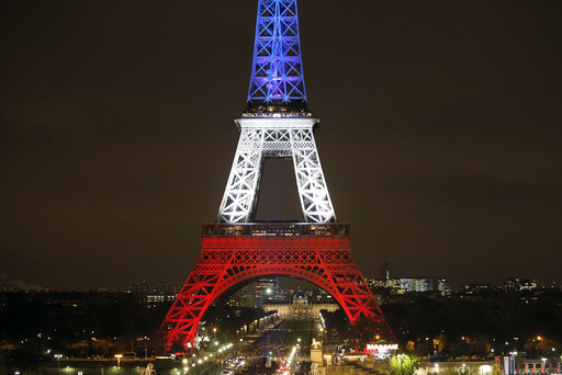 The Eiffel Tower is lit with the blue, white and red colours of the French flag in Paris to pay tribute to the victims of a series of deadly attacks on Friday in the French capital