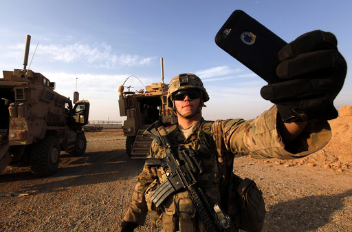An American soldier takes a selfie at the U.S. army base in Qayyara, south of Mosul
