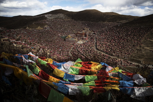 Tibetan prayer flags flutter above the Larung valley and its Larung Wuming Buddhist Institute, located some 3700 to 4000 metres above the sea level in remote Sertar county, Garze Tibetan Autonomous Prefecture, Sichuan province, China