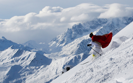 A man dressed as Santa Claus enjoys the snow during the Saint Nicholas Day at the Alpine ski resort of Verbier