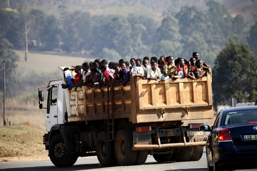 Maidens riding in the back of a dump truck arrive ahead of the last day of the Reed Dance at the Ludzidzini royal palace in Swaziland