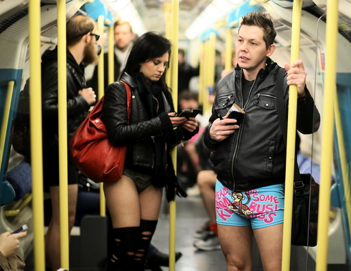 Participants in the annual No Trousers On The Tube Day ride the London Underground in London