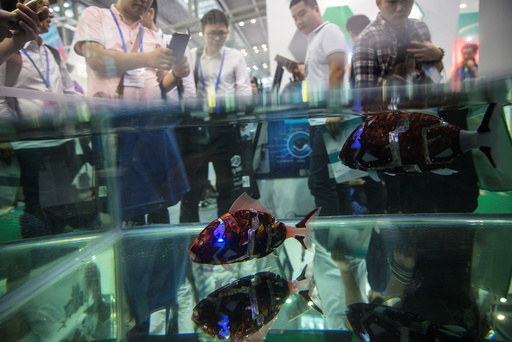 Fish robots swim in a pool during China Hi-Tech Fair in Shenzhen