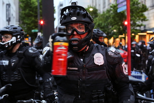 A police officer threatens to use pepper spray during May Day protests in Seattle, Washington