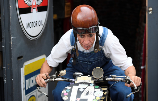An enthusiast attends the annual Goodwood Revival historic motor racing festival near Chichester