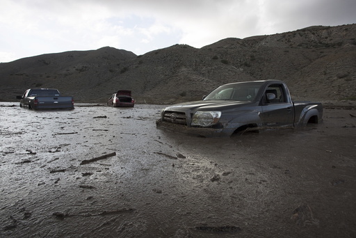 Cars and trucks remain mired in mud and debris on State Route 58 near Tehachapi