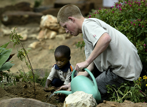PRINCE HARRY PLANTS A TREE AT THE MANTS'ASE CHILDRENS HOME NEAR MAHLES HOEK IN LESOTHO.