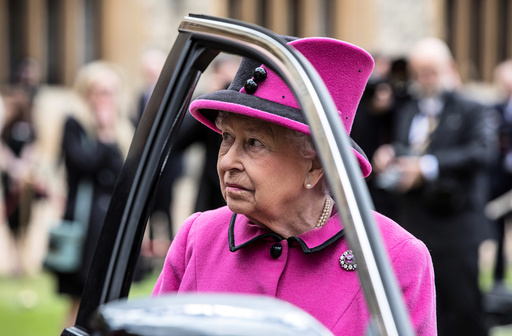 Britain's Queen Elizabeth talks to recipients of new 