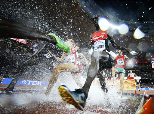 Ezekiel Kemboi of Kenya jumps a water obstacle in the men's 3000 metres steeplechase final during the 15th IAAF World Championships at the National Stadium in Beijing