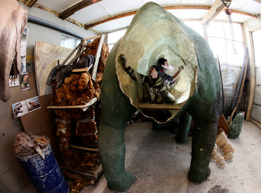Assistants of businessman Yan-Vin-Tin create a sculpture at a workshop outside Krasnoyarsk