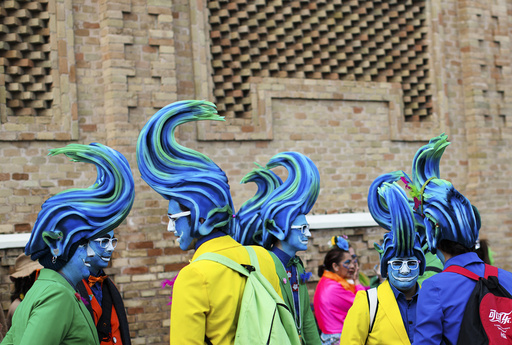 Men in fancy costumes chat during the Carnival of Cadiz
