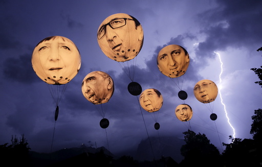 Lightning strikes the Alpine mountains as balloons depicting leaders of the G7 countries are inflated in Garmisch-Partenkirchen
