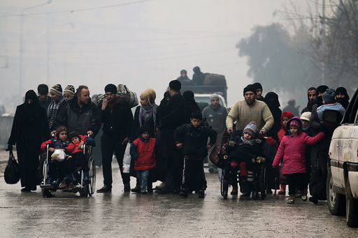 People walk as they flee deeper into the remaining rebel-held areas of Aleppo