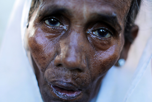 A Rohingya refugee woman rests after crossing the Myanmar-Bangladesh border in Palang Khali