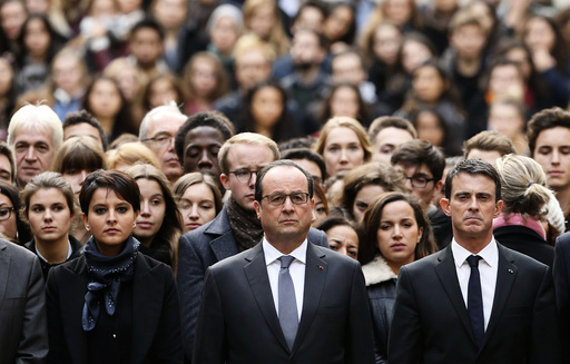 French President Francois Hollande observes a minute of silence at the Sorbonne University in Paris to pay tribute to victims of Friday's Paris attacks
